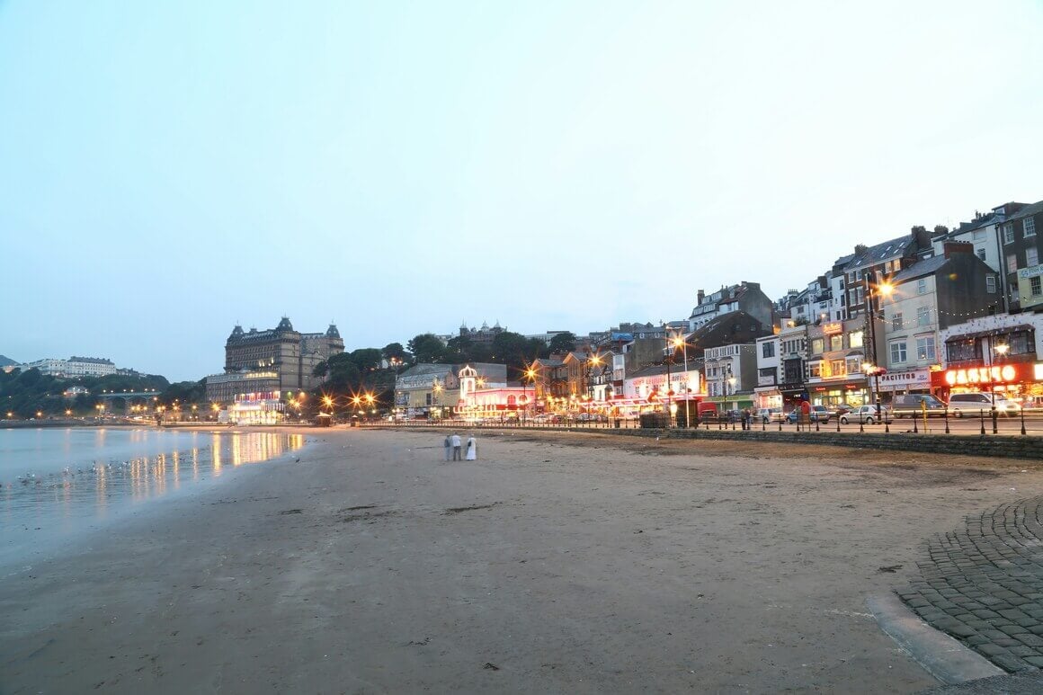 Scarborough beach with the lights of the city rising in the background.