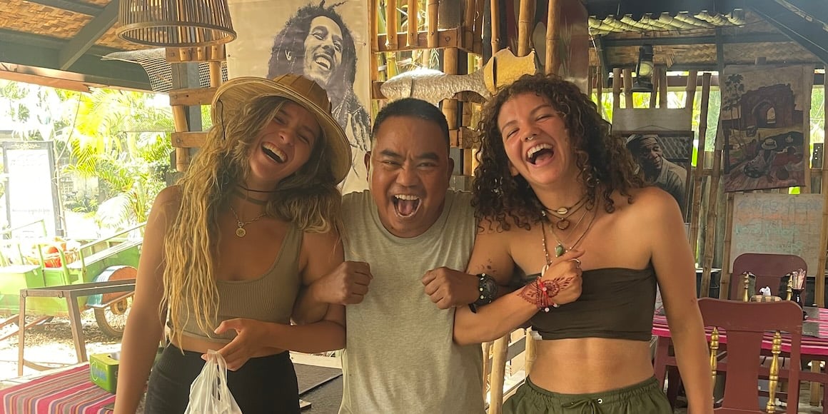 Audy and Amanda posing for a photo with a happy local in Myanmar.