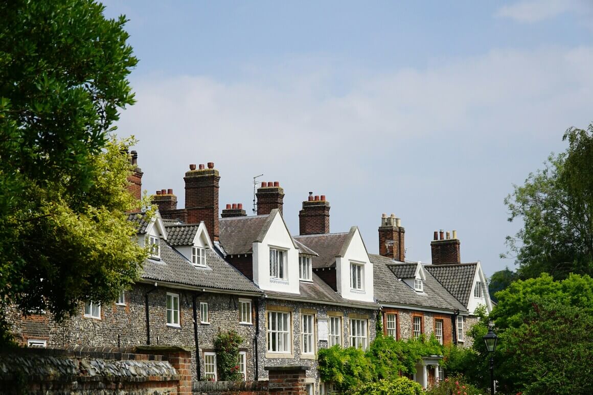 A row of colorful terraced houses with brick chimneys in Norwich, United Kingdom
