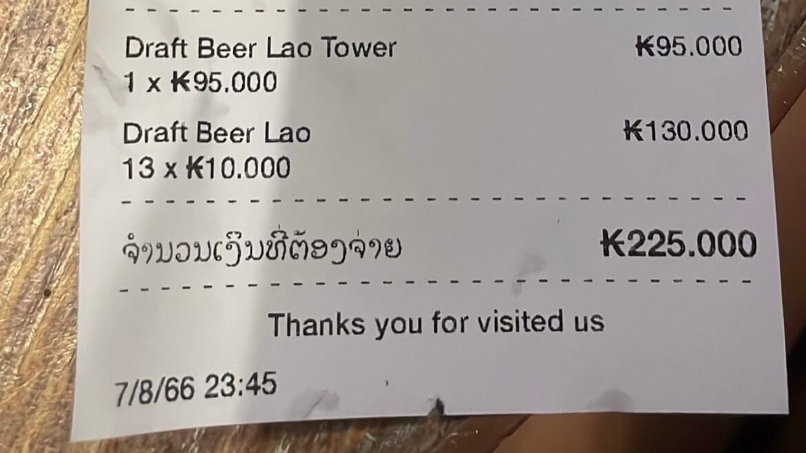 a picture of a bill of insanely cheap beers at a bar in vientiane