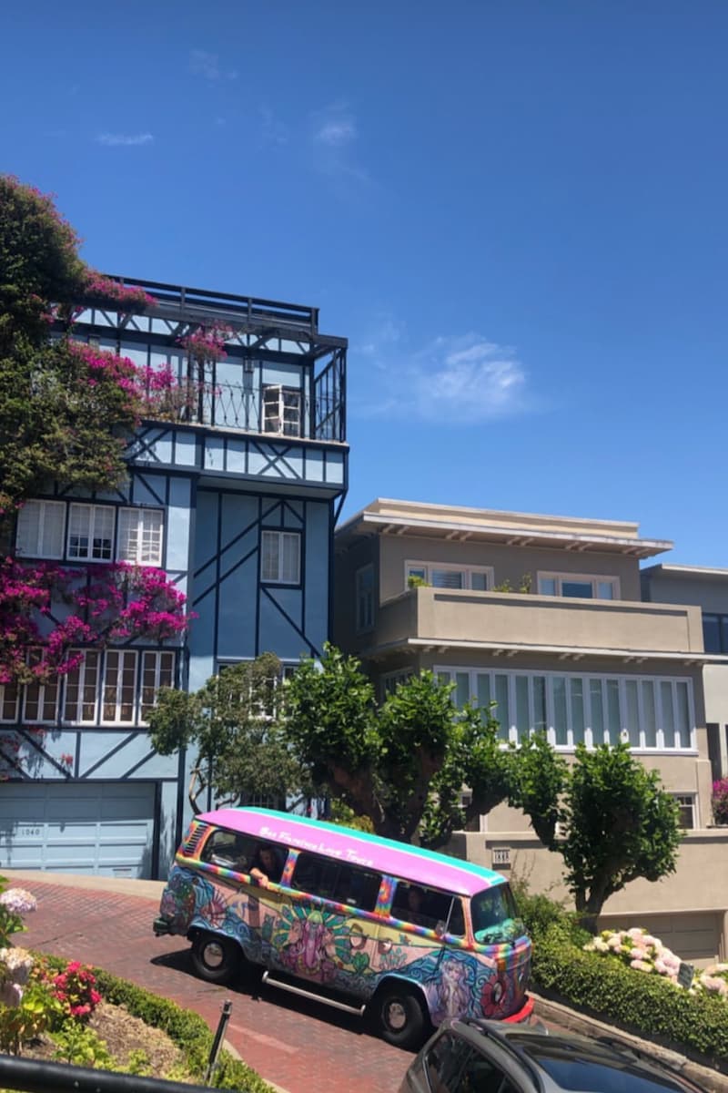 A hippie volkswagen van driving down the colorful streets of san francisco, california, usa  