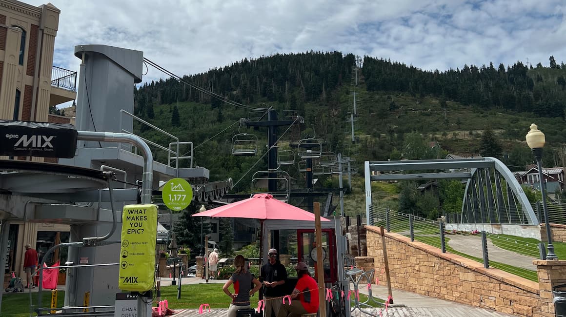 a ski lift bringing people to the top of the mountain on a sunny day in park city utah 
