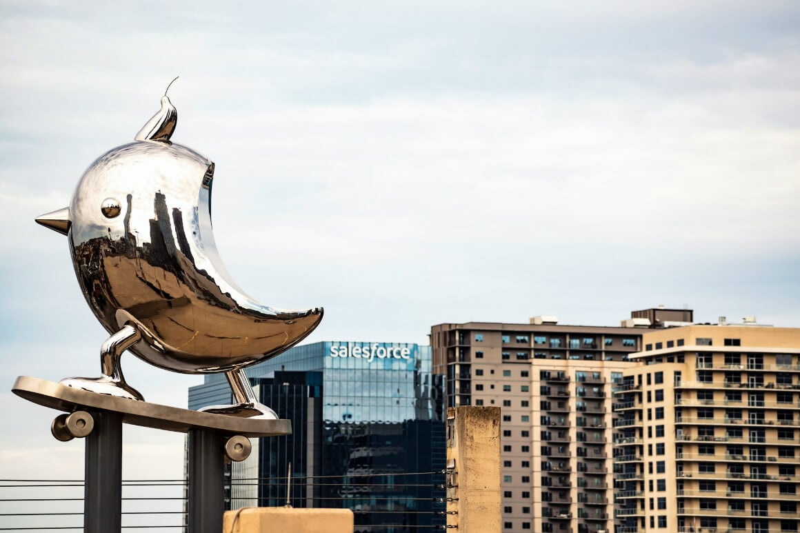 a bird art installation in front of sky scrapers in the arts district, dallas