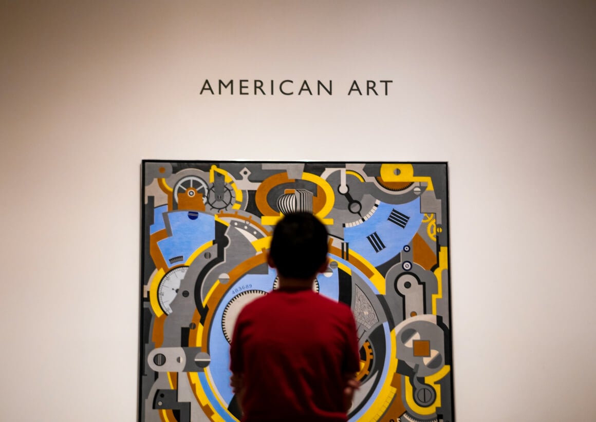 a boy looking at art in n art gallery in the arts district