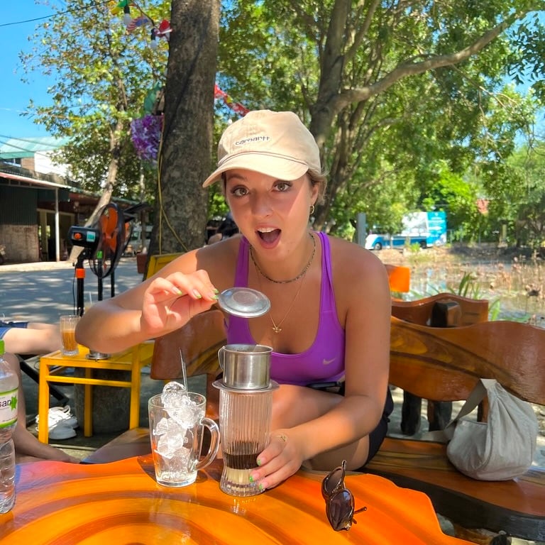 Taya posing with a vietnamese drip coffee in vietnam
