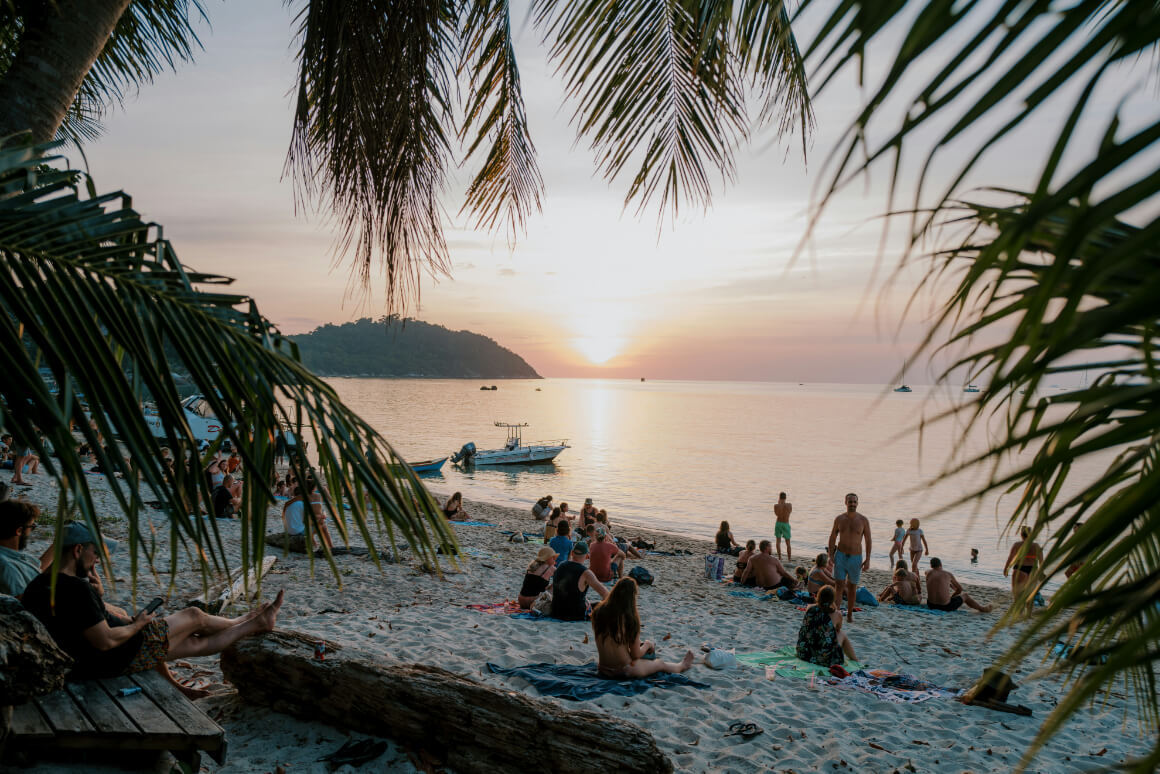 people staying in Koh Lipe viewing the sunset at the beach