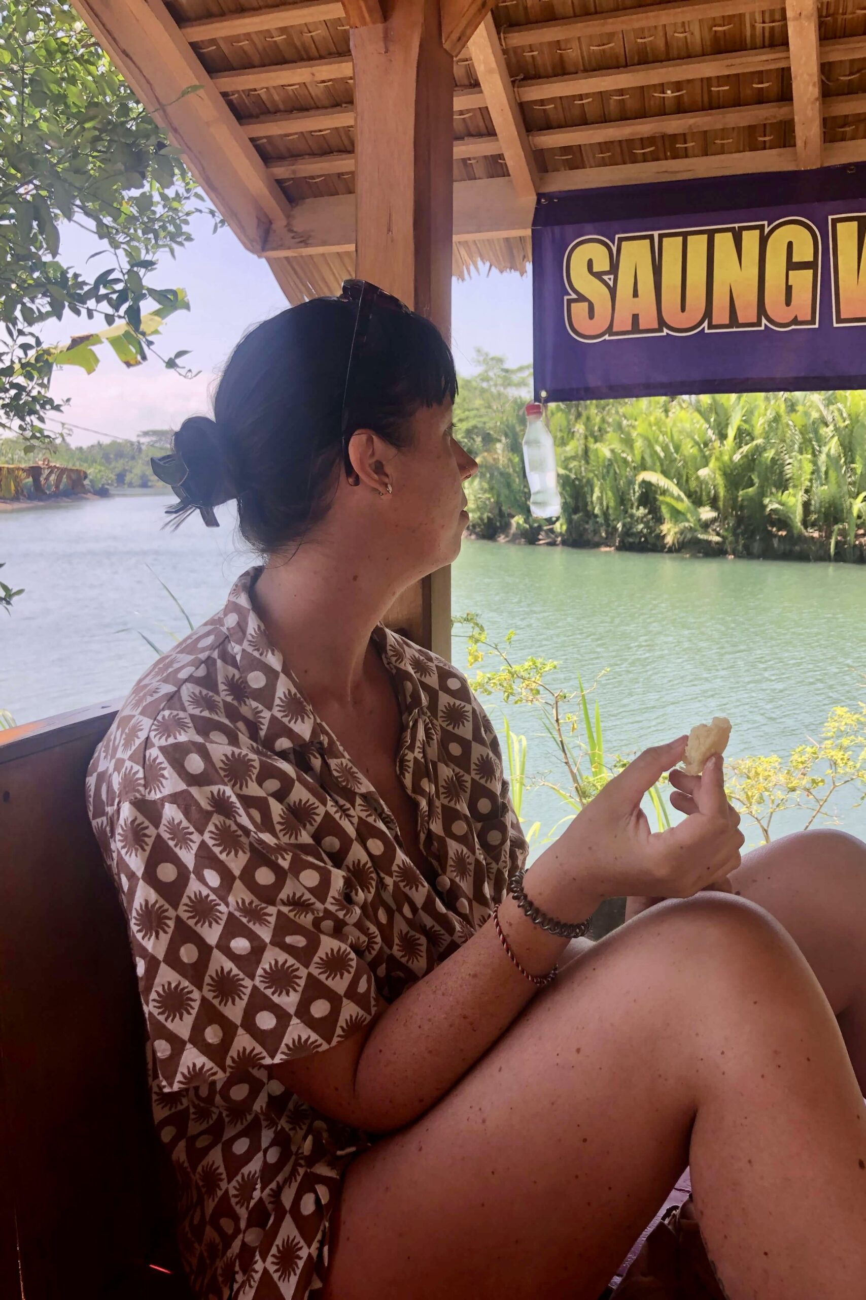 Sitting by the river eating lunch at Ma Engkar's warung, West Java, Indonesia