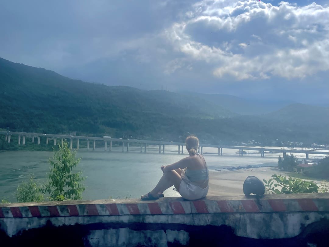 girl looking out to a bridge on the hai van pass, vietnam