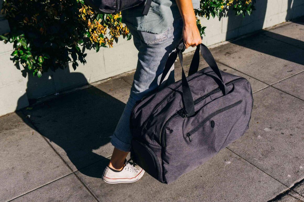 traveller carrying setout duffel bag
