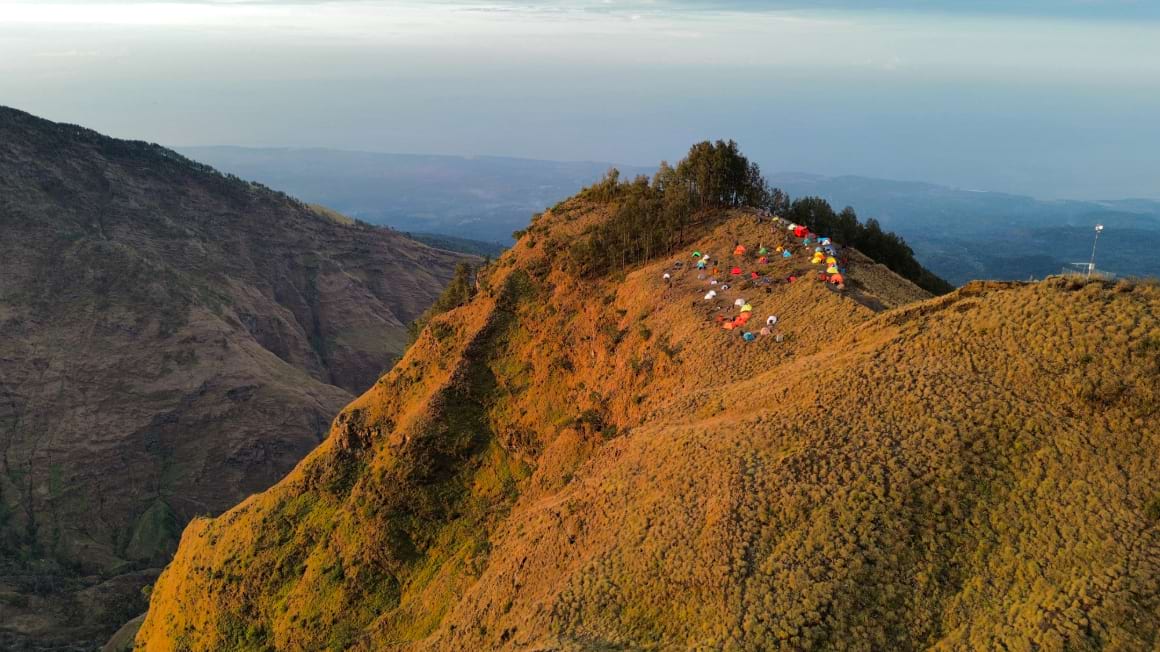 mount rinjani drone shot camp tents golden hour sunset