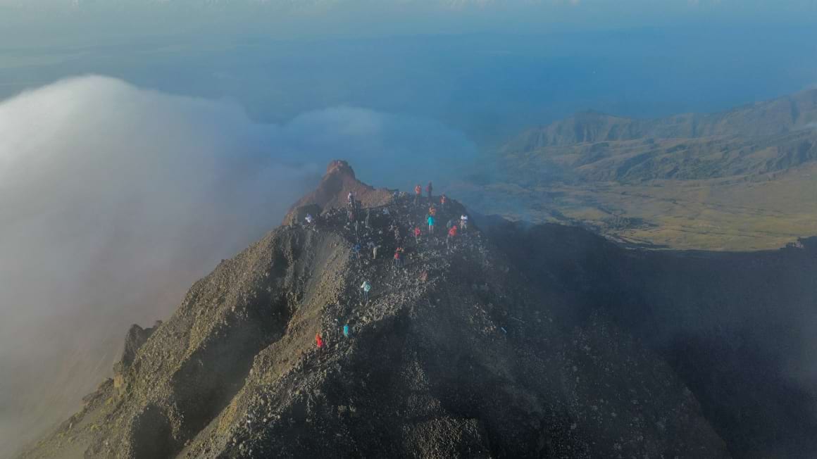mount rinjani drone shot people hikers rock summit