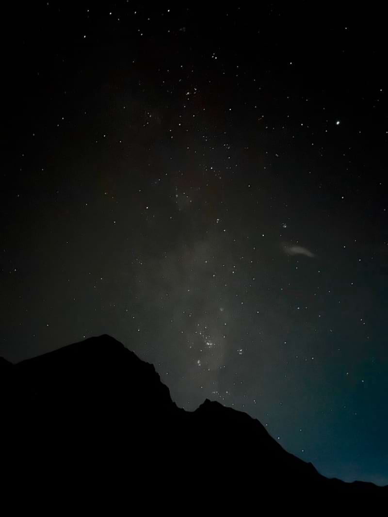 mount rinjani night sky with stars and an outline of a mountain