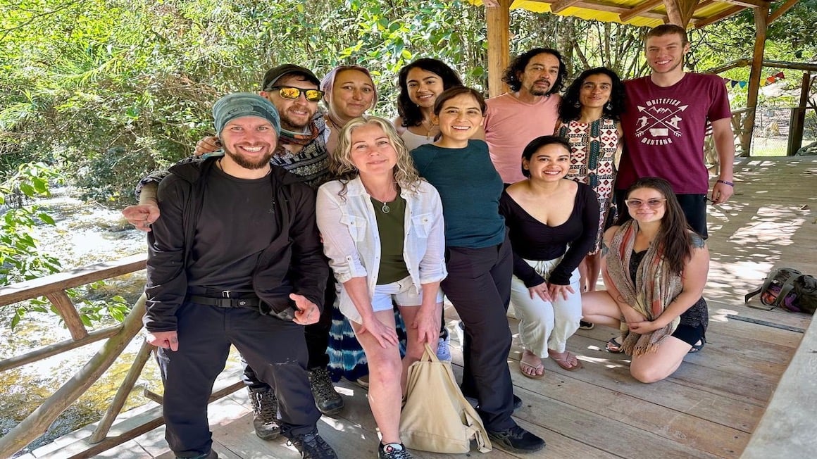 will at a spiritual medicine retreat in the mountains of ecuador with his brother alex and other participants standing on a wooden deck
