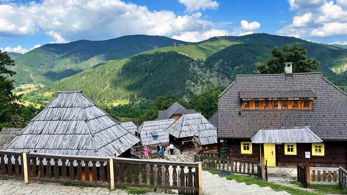 Drvengrad in Tara National Park with lush forested mountains behind