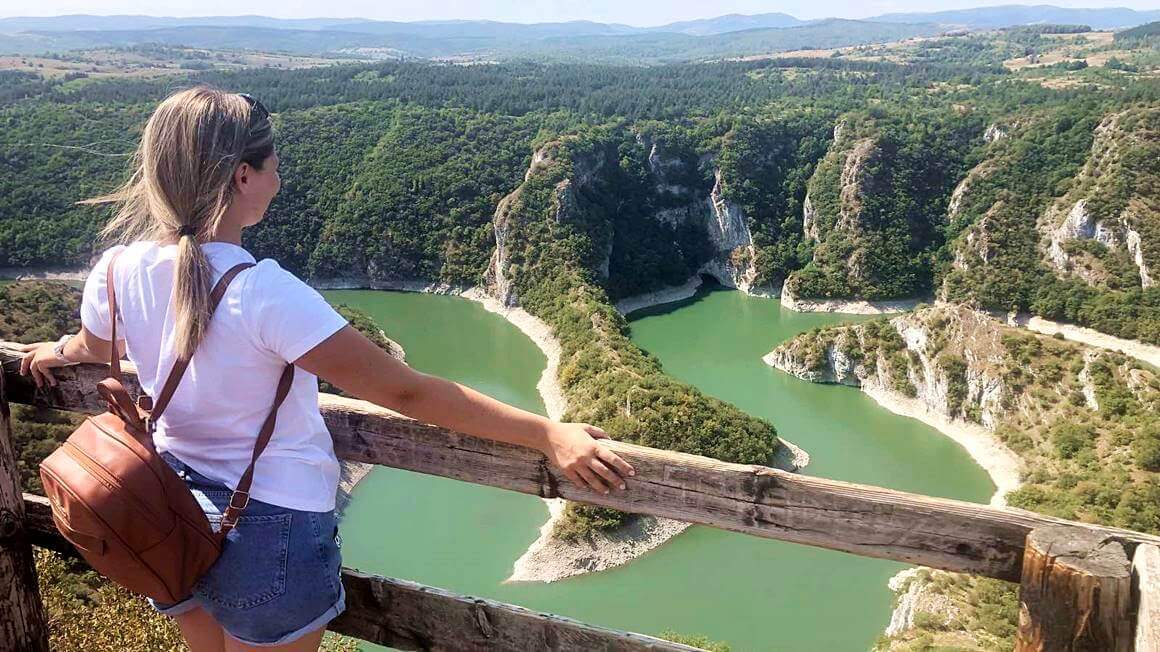 a woman standing looking out at Uvac Canyon