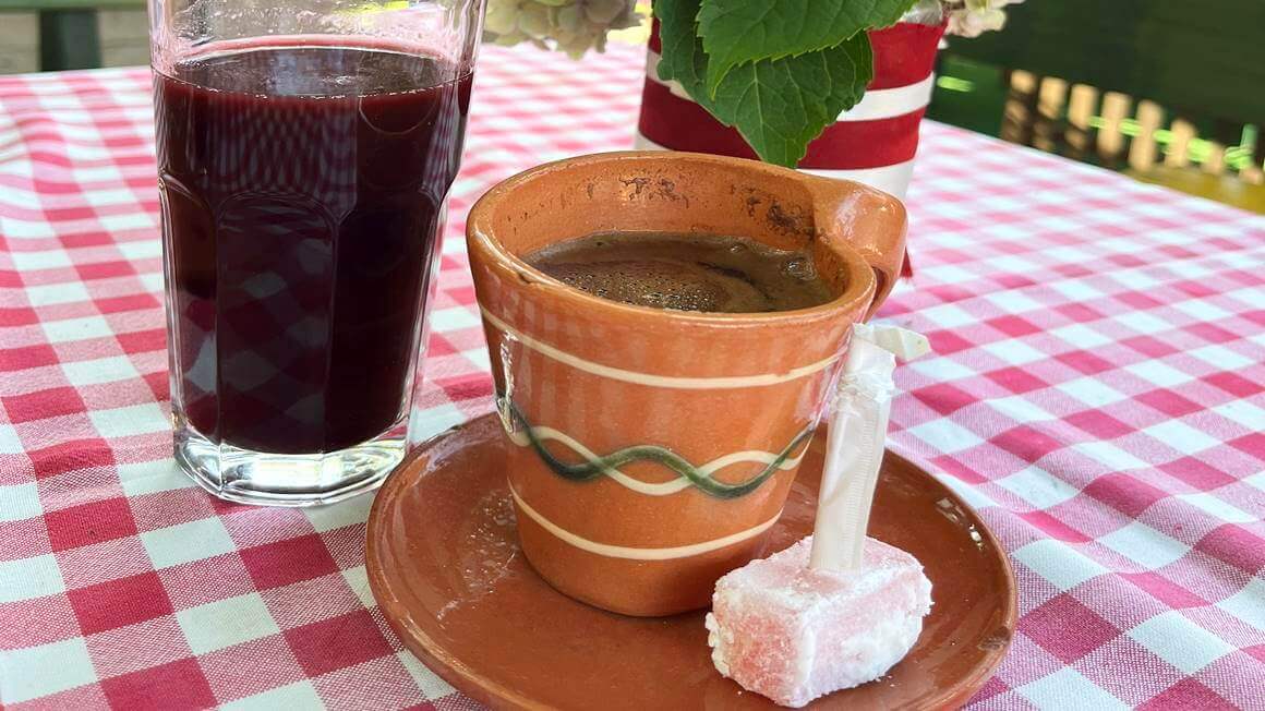 Serbian coffee sitting on a table with a red checkered table cloth