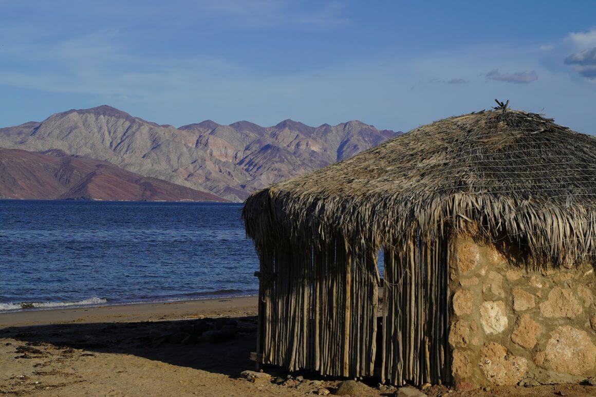 hut on the beach with mountains at bahia de los Angeles