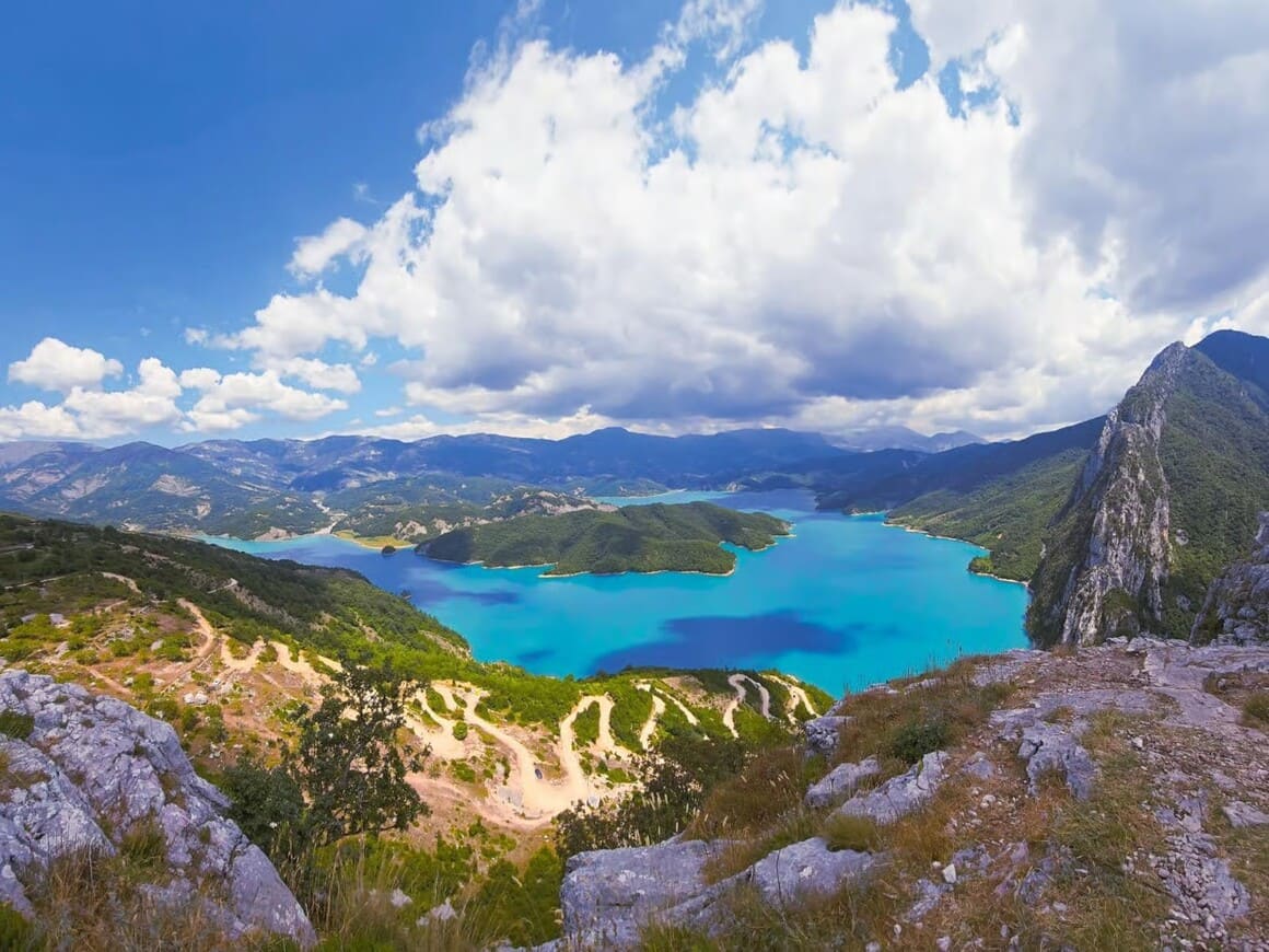 a view of the azure blue bovilla lake from a meadow above