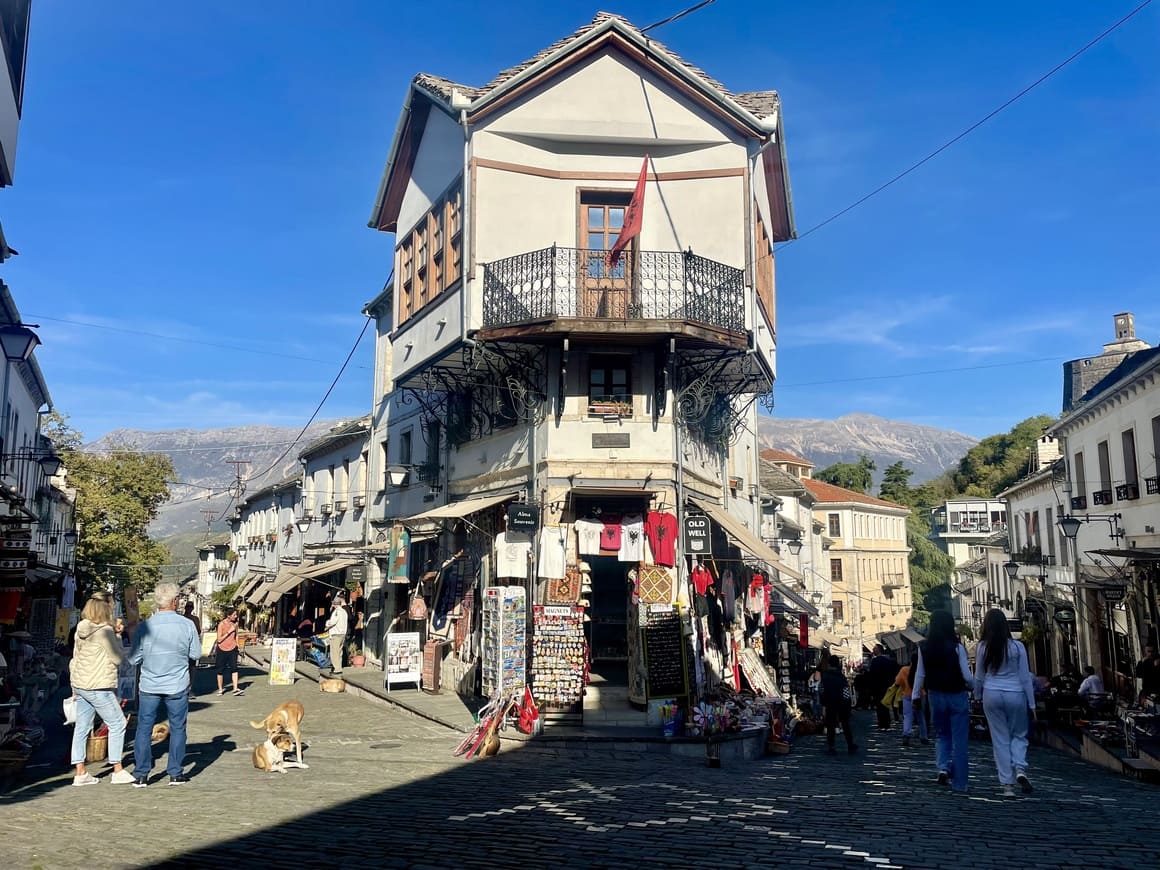 people walking around the gjirokaster old bazaar market in albania