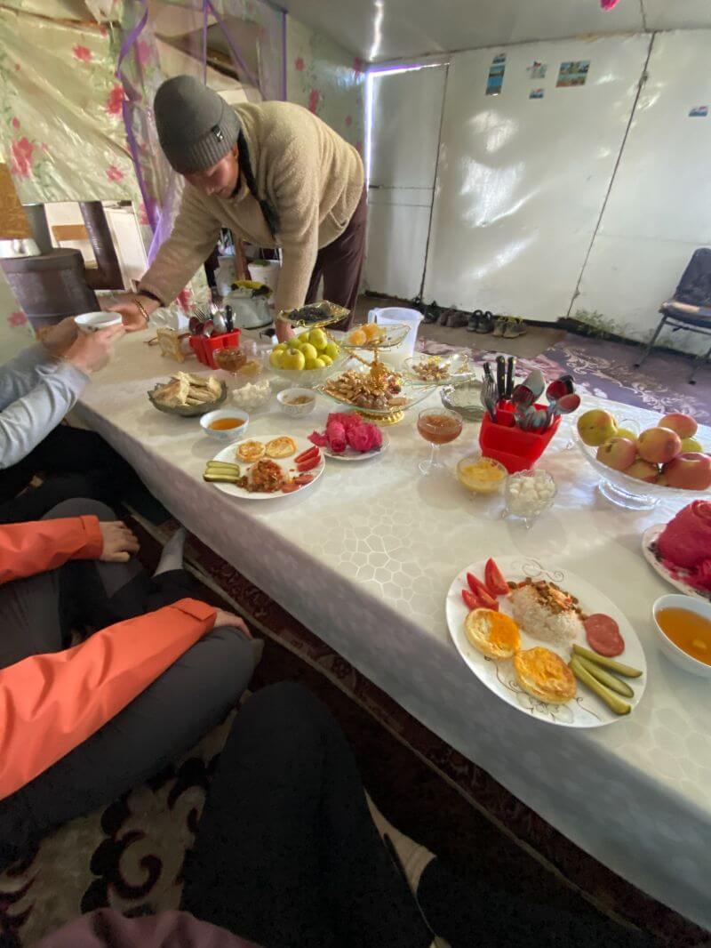 man serving traditional yurt breakfast