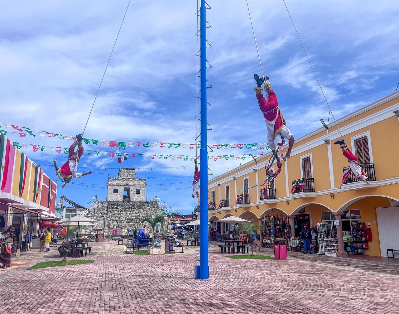 acrobats swinginng from a pole in town centre