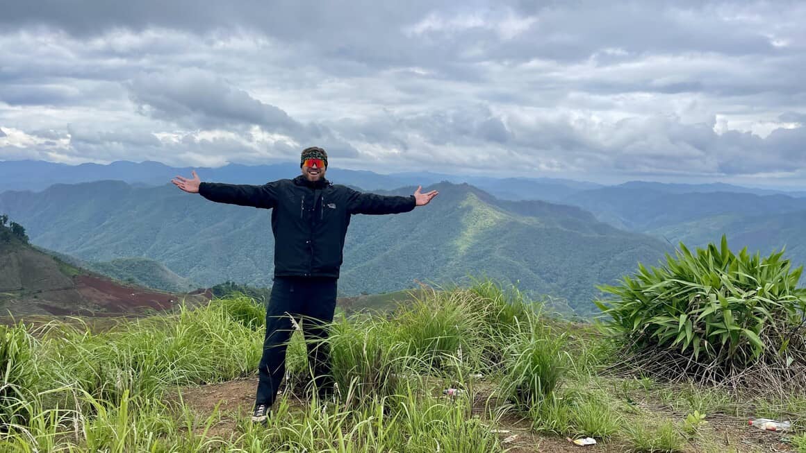 Harvey standing at the top mountain in Thailand