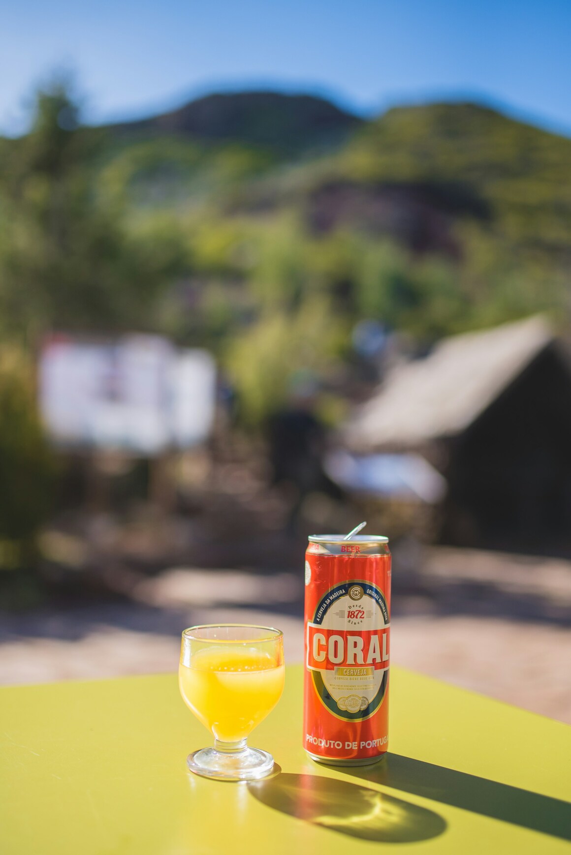 yellow poncha drink in a glass sitting on a table in madeira