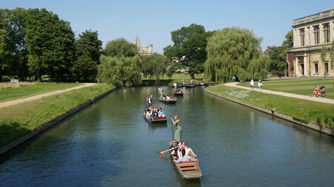 People punting down the river in Cambridge, England in the UK