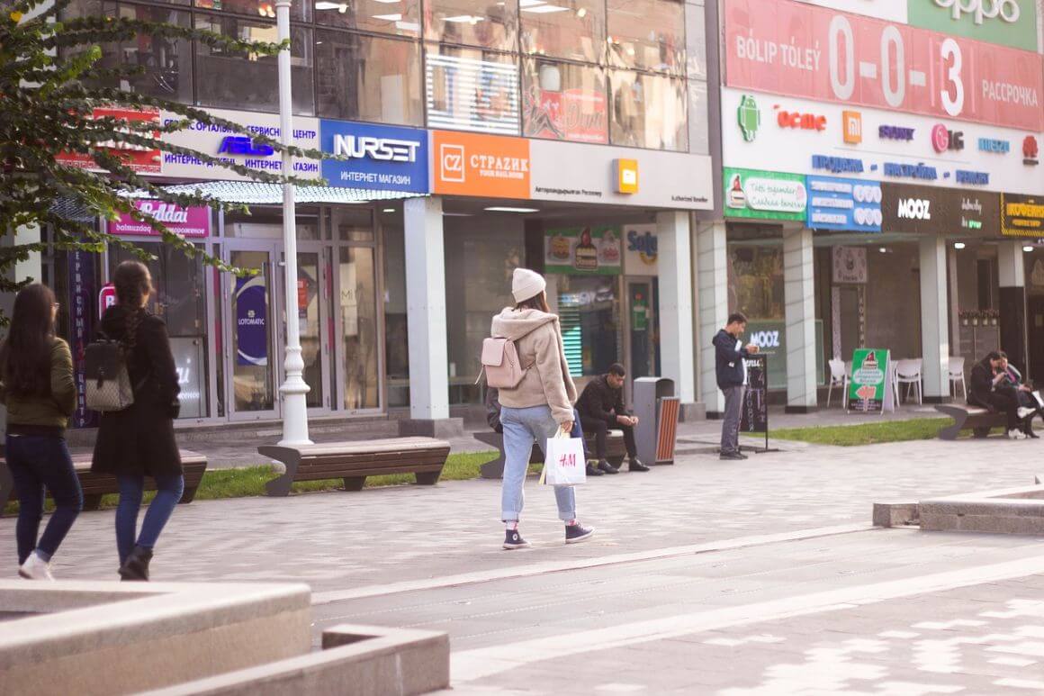 woman walking by shops at arbat street