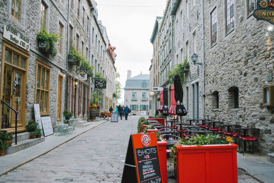 sidewalk full of restaurants and pubs in daytime