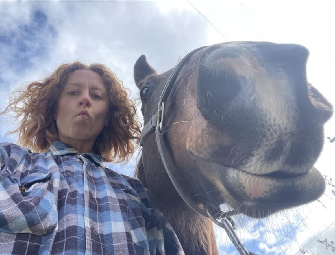 Maria taking a selfie with a horse, horse riding