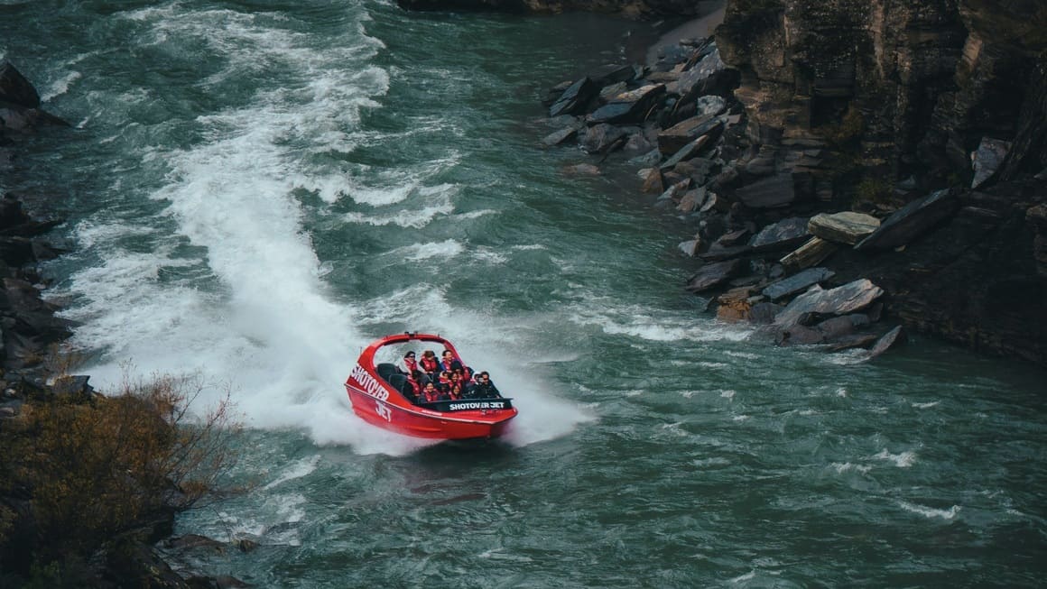 A group of people on the Shotover jet in Queenstown, New Zealad