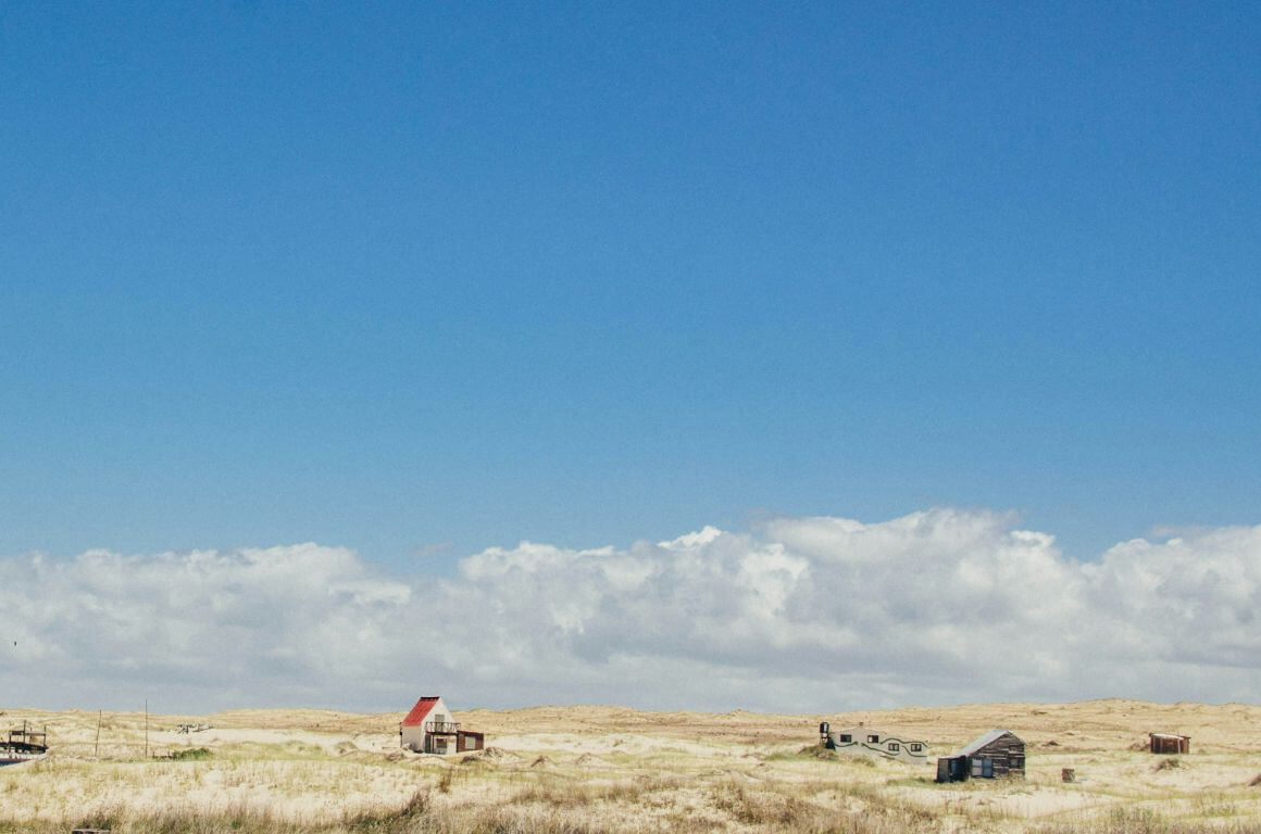 wide view of coastal village under clear blue skies