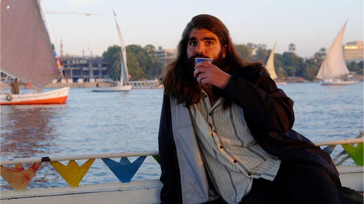 a traveller drinking tea in a boat in luxor, egypt