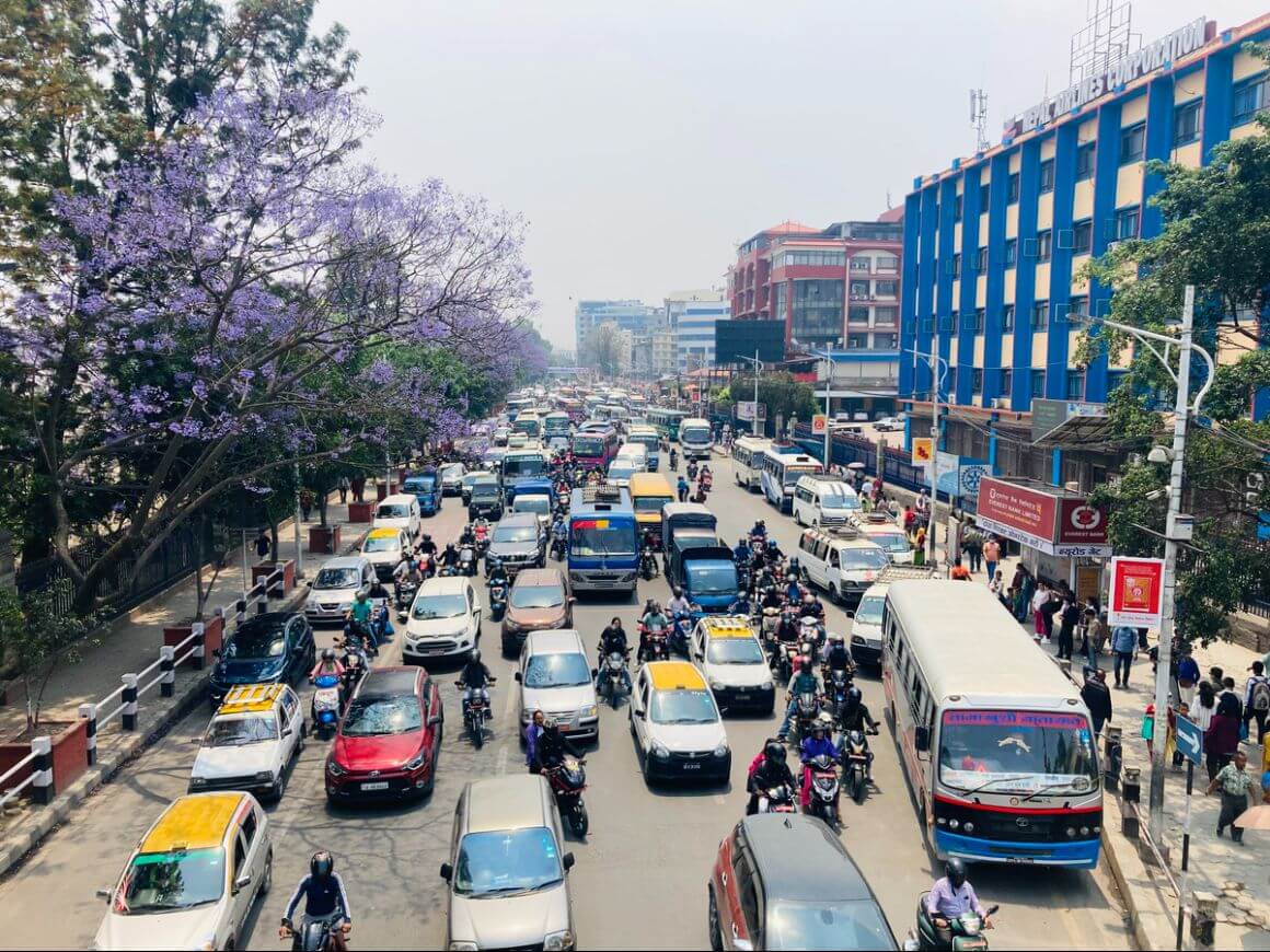 local transportations and cars stuck in wide street traffic