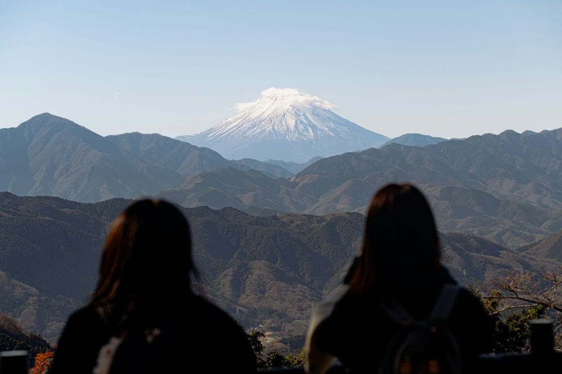 female tourist looking at mount fuji from mount takao