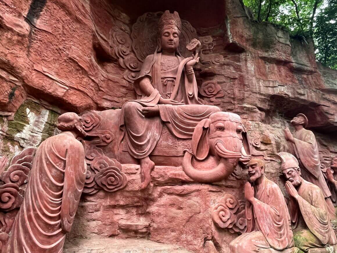 red stone carving of traditional chinese deity