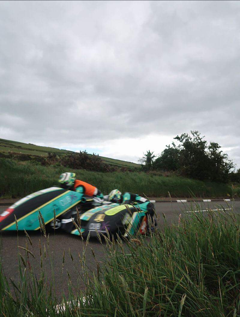 speeding racers in a green sidecar