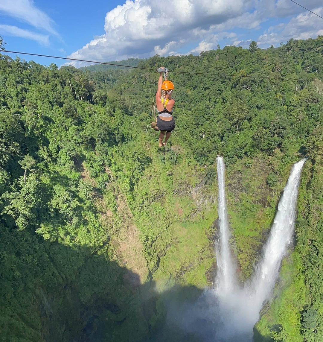 taya ziplining across tad fane waterfall, laos