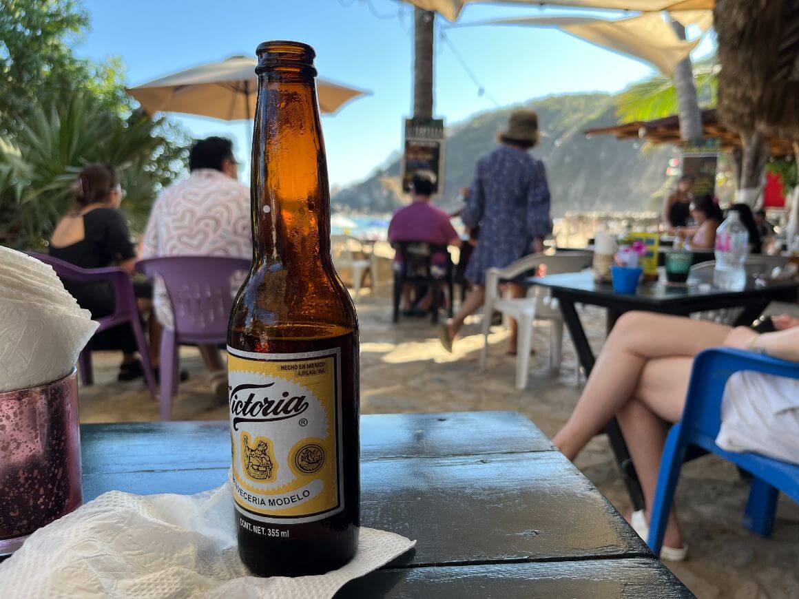 local mexican brewed beer, and a view of tourists on the background