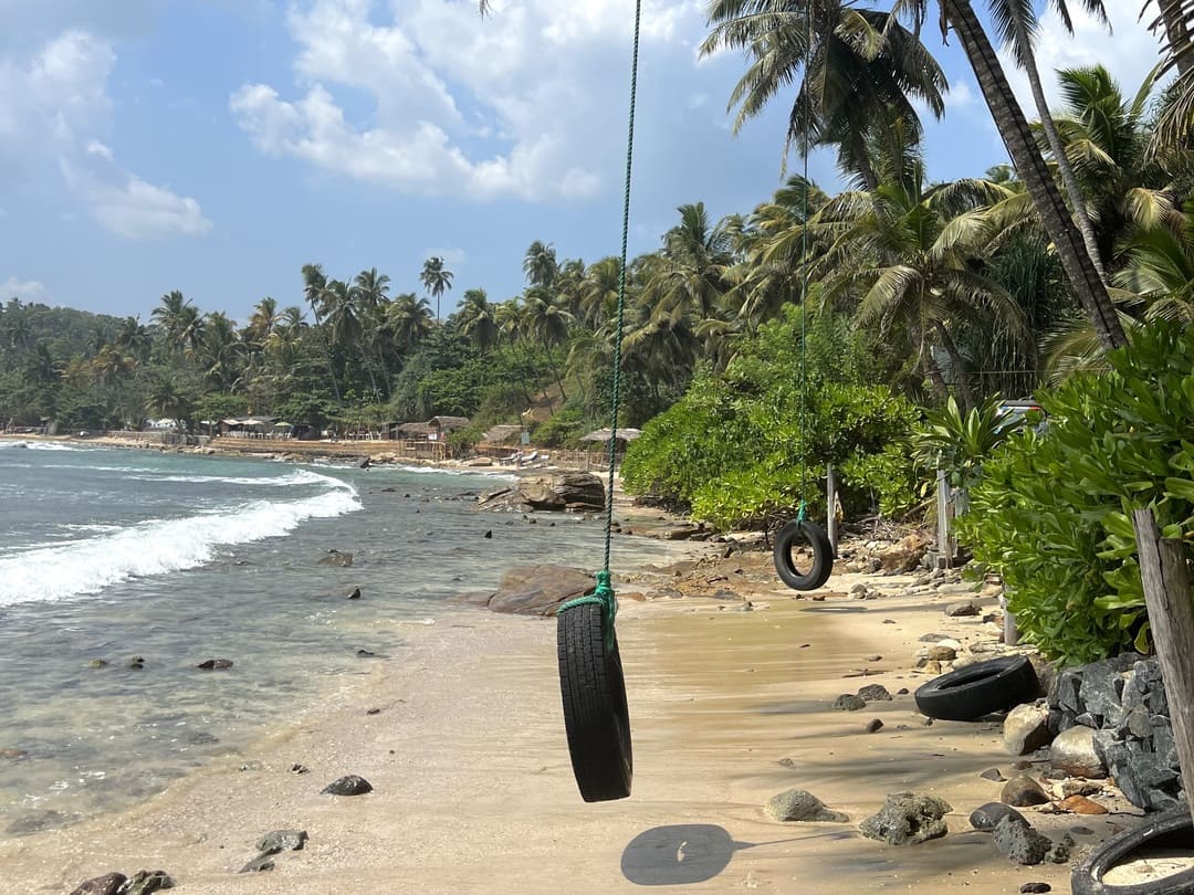 a rope swing on talalla beach, sri lanka