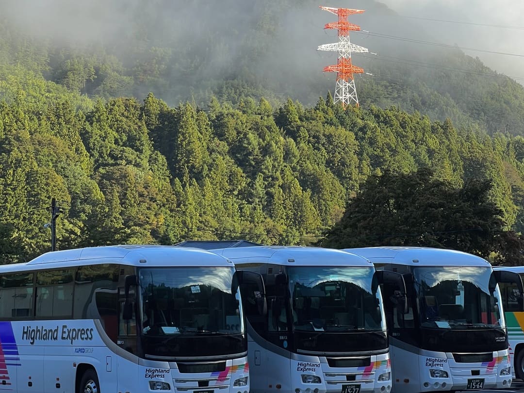 buses waiting to take people into kamikochi national park, japan