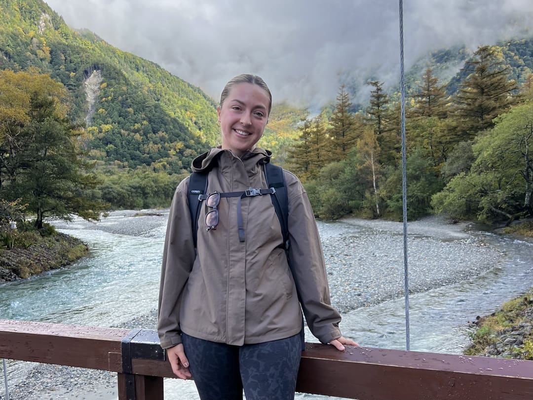 taya on a bridge along the azusa river, kamikochi