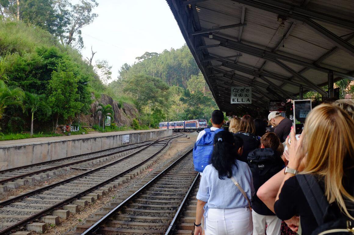 crowded passengers looking at train arrival