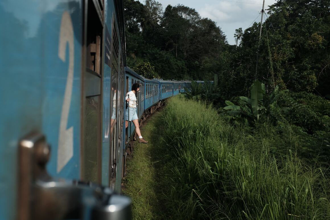 female traveller one feet hanging out the train