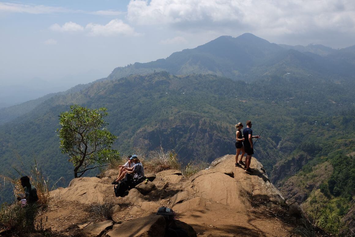 ella rock mountain peak with hikers sitting and taking photos