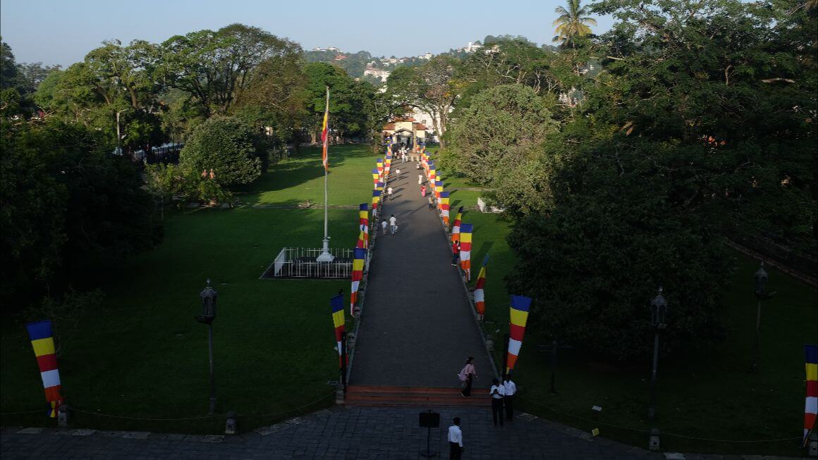 temple pathway full of blue, yellow,red,white,banners