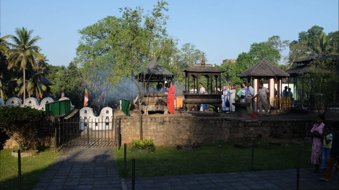 temple ground full of crowds with burning incense