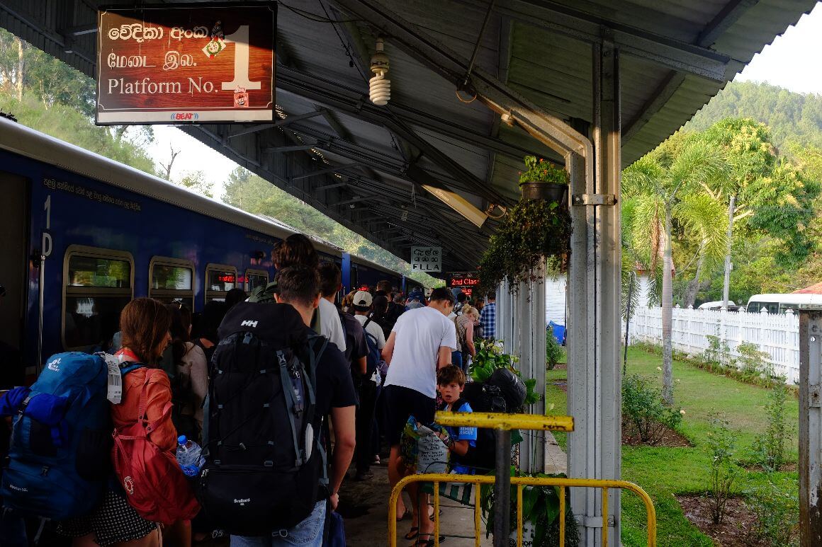 train platform full of crowded passengers