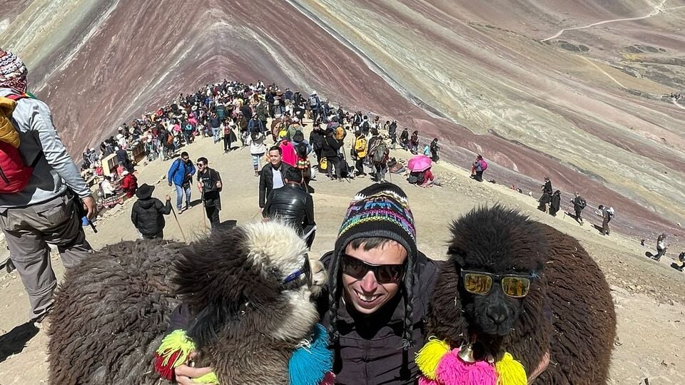Alex with a couple of cool-looking alpacas on Rainbow Mountain in Peru.